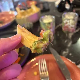 a hand holding a piece of food