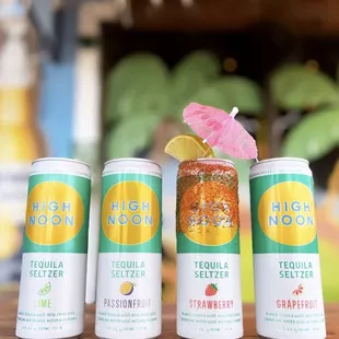 three cans of high noon seltzer on a table