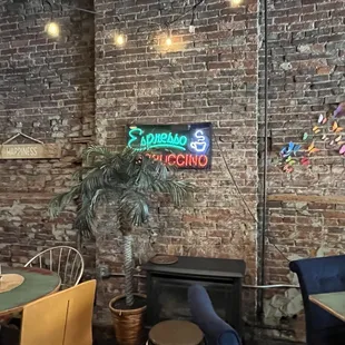 a brick wall with a neon sign