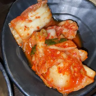 a plate of kimchi and noodles