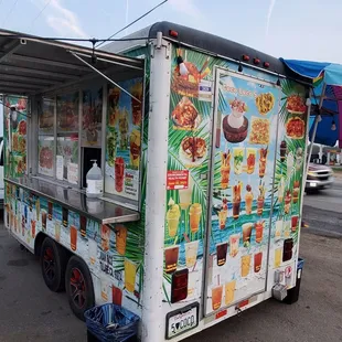 a food truck with an umbrella on the side