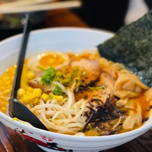 a bowl of ramen with chopsticks