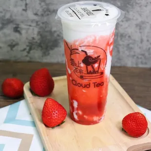 a drink with strawberries on a tray