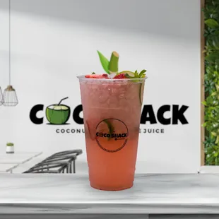 a pink drink with a lime garnish