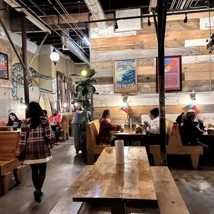 people sitting at tables in a restaurant