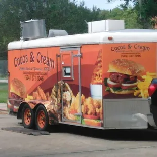 The trailer that is pulled by a truck and is the kitchen.