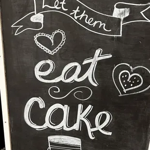 a chalkboard sign for a cake shop