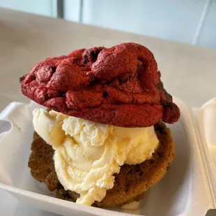 Red velvet cookie and chocolate chip cookie + vanilla Ice cream in a cookie sandwich