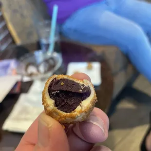 a hand holding a pastry
