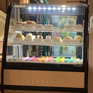 a display case with a variety of pastries