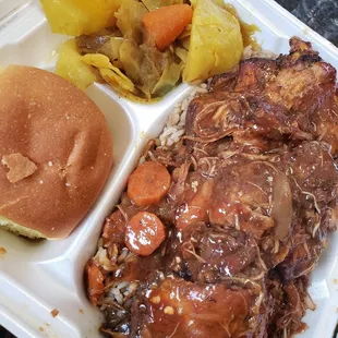 Brown stew chicken with perfect peas &amp; rice and a side of cabbage and a roll. Large platter. Huge portion. Delicious!!!