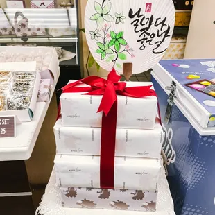 a stack of wrapped chocolates with a fan on top