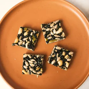 four pieces of chocolate and nuts on a plate
