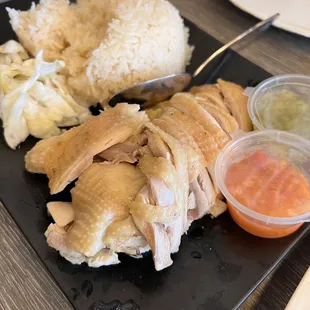 a plate of chicken, rice, and vegetables