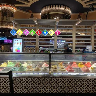 a variety of gelatos in a display case