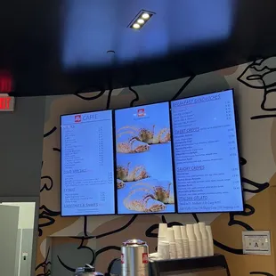 a coffee shop with a menu on the wall