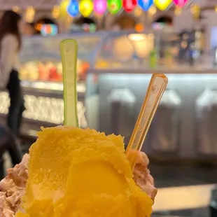 a hand holding a cone of ice cream