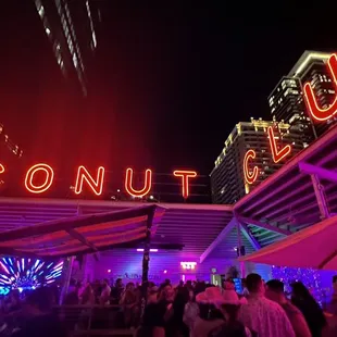 a neon sign in the background