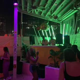 a group of people standing in front of a bar