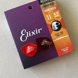 Elixir Phosphor Bronze 11|52 acoustic guitar strings and Herco guitar picks.