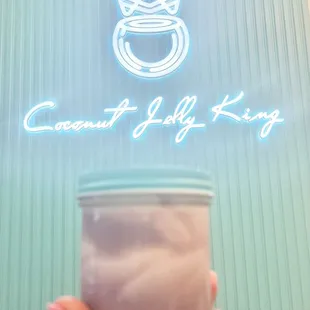 a hand holding a cup of ice cream