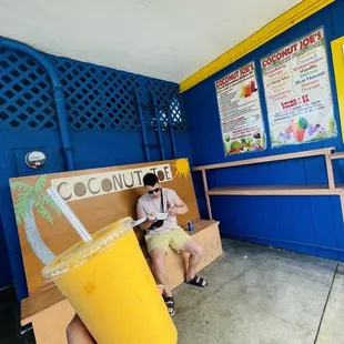 Coconut Joe bench, smoothie, and my boo enjoying his hot lemon shrimp plate from Aloha Shrimp next door