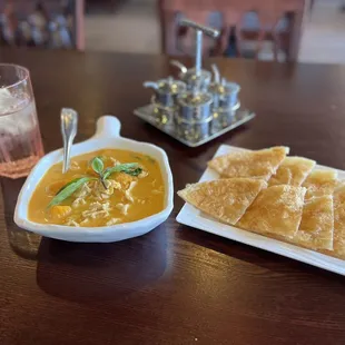 a plate of tortillas and a bowl of soup
