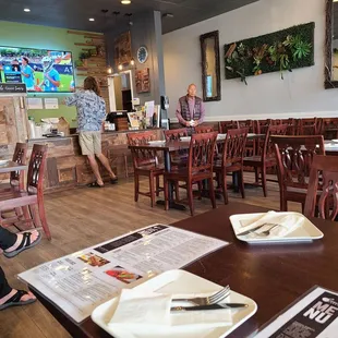 a woman sitting at a table in a restaurant