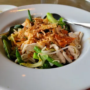 Warm salad on a bed of fresh spinach.  Chicken and cooked veggies on top.  Curry sauce has lime and coconut flavors with it.