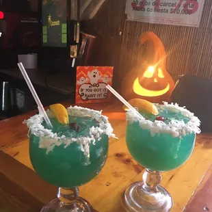 two cocktails on a wooden table