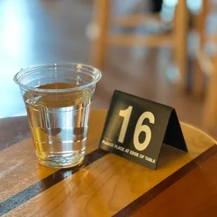 a glass of water and a table number