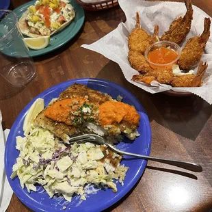 Mahi mahi over rice with coleslaw, Coconut Shrimp, fish tacos