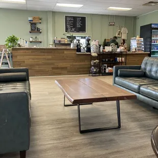 a coffee shop with leather couches and a coffee table
