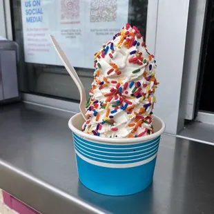 Regular SOFT SERVE in a cup with rainbow sprinkles