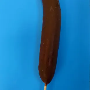 a chocolate banana on a stick