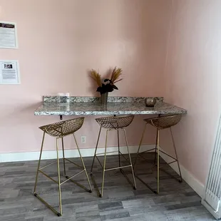 a pink room with marble counter tops