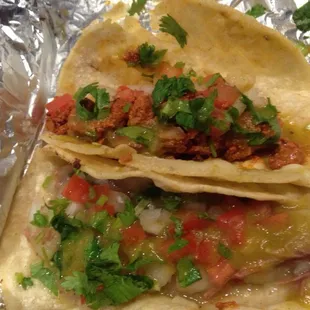 Desebrada con papa (shredded beef with potato) and al pastor (spicy pork) taco.