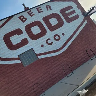 a red brick building with a white sign