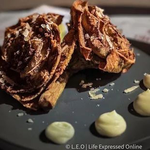 a plate of waffles and cream