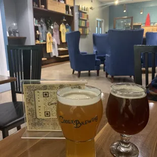 two glasses of beer on a table