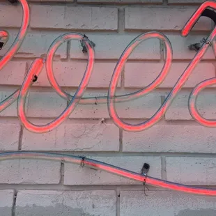 neon neon sign on brick wall