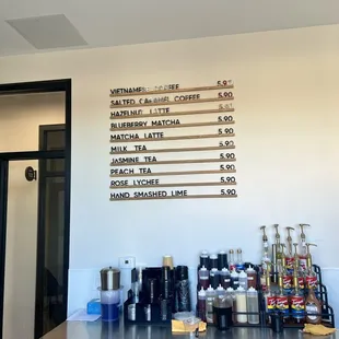 a menu on the wall of a coffee shop