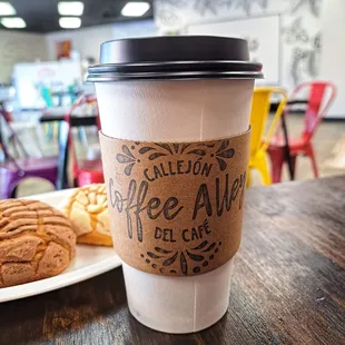 a cup of coffee and a plate of cookies