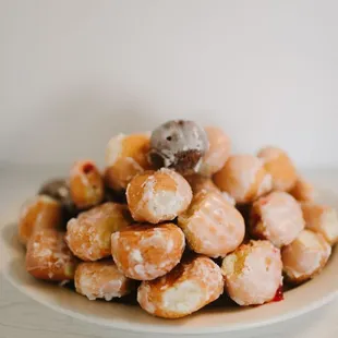 a pile of donuts on a plate