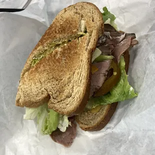 Roast beef on whole wheat with everything on it except onion.