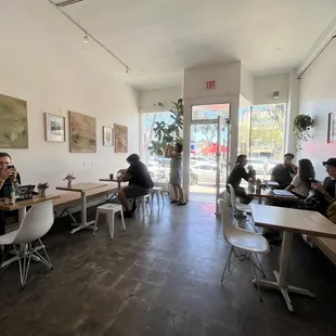 people sitting at tables in a coffee shop