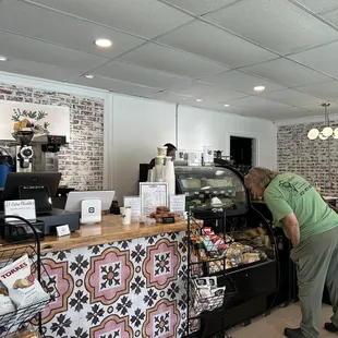 a woman standing in front of a counter