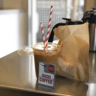 a cup of coffee and a paper bag