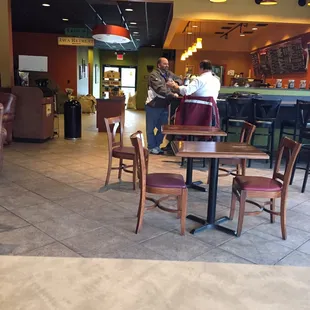 people sitting at tables in a coffee shop