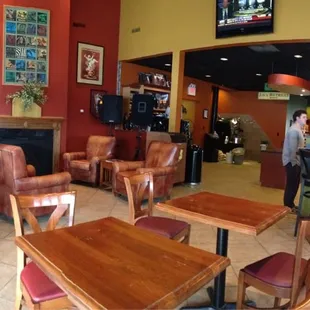 people sitting at tables in a coffee shop